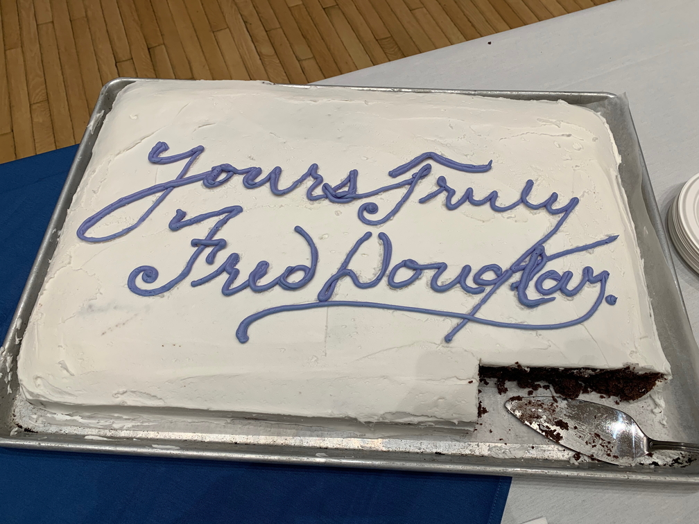 Cake with the words Yours Truly, Frederick Douglass written in icing