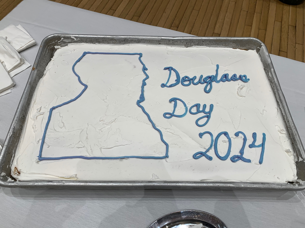 Cake with the words Douglass Day 2024 written in icing